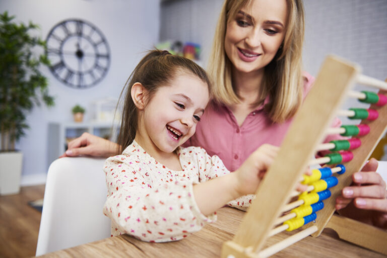 Girl and teacher using an abacus during homeschooling